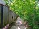 Walkway lined by a rustic wooden fence and lush greenery leading to a peaceful community at 4268 Foxglove Trce, Indianapolis, IN 46237