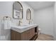 Modern bathroom featuring a double vanity, marble countertops, and gold fixtures at 450 Pleasant St, Noblesville, IN 46060