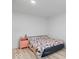 Simple bedroom featuring hardwood floors and a patterned comforter at 450 Pleasant St, Noblesville, IN 46060