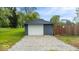 A single-car detached garage with a gravel driveway provides additional storage space at 450 Pleasant St, Noblesville, IN 46060