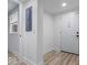 Hallway featuring hardwood floors, white walls, and a window at 450 Pleasant St, Noblesville, IN 46060