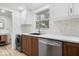 Well-equipped kitchen showcasing stainless steel appliances, wooden cabinets, and tile backsplash at 450 Pleasant St, Noblesville, IN 46060