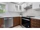 Modern kitchen featuring white cabinets, stainless steel appliances, and stylish backsplash at 450 Pleasant St, Noblesville, IN 46060