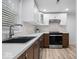 Updated kitchen boasts white cabinets, stainless steel appliances, and stylish backsplash at 450 Pleasant St, Noblesville, IN 46060