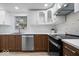 Contemporary kitchen with white upper cabinets, wood lower cabinets, and stainless steel appliances at 450 Pleasant St, Noblesville, IN 46060