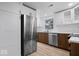 Updated kitchen features stainless steel refrigerator and appliances with a view to the outside at 450 Pleasant St, Noblesville, IN 46060