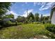 Spacious backyard with lush greenery, mature trees, and a full perimeter fence at 4625 N Sadlier Dr, Indianapolis, IN 46226