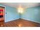 Bedroom features laminate floors, blue walls and natural light from doorway at 4625 N Sadlier Dr, Indianapolis, IN 46226