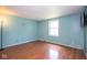 Bedroom featuring wood floors, blue walls and natural light from window at 4625 N Sadlier Dr, Indianapolis, IN 46226