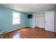 Bedroom with wood floors, blue walls, closet and bright natural light at 4625 N Sadlier Dr, Indianapolis, IN 46226