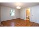 Bedroom featuring wood-look floors, a window and ensuite bathroom at 4625 N Sadlier Dr, Indianapolis, IN 46226