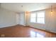 Living room featuring wood-look floors, windows and white door at 4625 N Sadlier Dr, Indianapolis, IN 46226