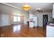 Living room view, including kitchen with white cabinets and appliances at 4625 N Sadlier Dr, Indianapolis, IN 46226
