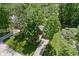Aerial view of a home nestled among lush trees, with a neatly landscaped yard and a long driveway at 469 Ash Dr, Carmel, IN 46032
