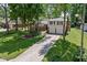 Scenic aerial shot of a home featuring a spacious lawn, mature trees, and a convenient two-car garage at 469 Ash Dr, Carmel, IN 46032