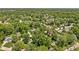 An aerial view showcasing a densely wooded neighborhood with a variety of homes, balancing nature and residential living at 469 Ash Dr, Carmel, IN 46032