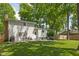 Spacious backyard with a patio area, perfect for outdoor dining and relaxation, surrounded by lush greenery and mature trees at 469 Ash Dr, Carmel, IN 46032