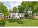 Expansive backyard featuring an outdoor dining area, a patio and a manicured lawn at 469 Ash Dr, Carmel, IN 46032