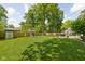 Expansive backyard featuring a play set, storage shed, and ample green space for recreation at 469 Ash Dr, Carmel, IN 46032