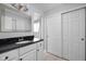 Clean bathroom featuring a modern black countertop, white cabinets, and a well-lit mirror at 469 Ash Dr, Carmel, IN 46032
