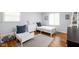 Bright, airy bedroom featuring two twin beds with white wood frames and blue accents at 469 Ash Dr, Carmel, IN 46032
