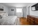 Serene main bedroom with hardwood floors, neutral decor, and a large window providing natural light at 469 Ash Dr, Carmel, IN 46032