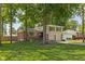 Beautiful home with a brick and siding exterior, featuring an attached garage and a spacious front yard with mature trees at 469 Ash Dr, Carmel, IN 46032