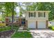 Charming home featuring a brick facade, attached two-car garage, and a well-maintained front yard with mature trees at 469 Ash Dr, Carmel, IN 46032