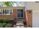 Inviting front entrance featuring a blue double door, brick accents, and well-manicured landscaping, adding curb appeal at 469 Ash Dr, Carmel, IN 46032