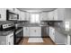 Modern kitchen with white cabinets, granite countertops, stainless steel appliances, and stylish backsplash, offering a sleek design at 469 Ash Dr, Carmel, IN 46032