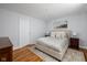 Serene main bedroom with a plush bed, wood floors, soft lighting, and a calm ambiance for a restful retreat at 469 Ash Dr, Carmel, IN 46032