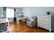 Comfortable home office with hardwood floors, soft gray armchair, and great natural light at 469 Ash Dr, Carmel, IN 46032