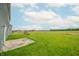 View of a spacious backyard featuring a patio and well-maintained lawn at 4712 Clairmont Dr, Columbus, IN 47203
