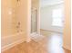 Well-lit bathroom featuring a shower-tub combo, and tile flooring at 4712 Clairmont Dr, Columbus, IN 47203
