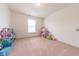 Bright bedroom featuring neutral walls and carpet, and plenty of space for play and relaxation at 4712 Clairmont Dr, Columbus, IN 47203