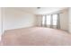 Spacious bedroom with carpet flooring and multiple windows for ample natural light at 4712 Clairmont Dr, Columbus, IN 47203