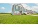 Two-story home with light blue siding and a well-maintained lawn at 4712 Clairmont Dr, Columbus, IN 47203