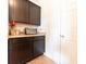 Kitchen counter space featuring dark cabinets and a cream colored countertop at 4712 Clairmont Dr, Columbus, IN 47203