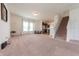 Bright living room with plush carpeting and an open floor plan at 4712 Clairmont Dr, Columbus, IN 47203