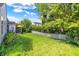 The large backyard offers a lush lawn, brick patio, fire pit and white picket fence at 4824 Eagles Watch Ln, Indianapolis, IN 46254