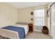 Simple bedroom with a bed, bedside table, and a window providing natural light at 4824 Eagles Watch Ln, Indianapolis, IN 46254