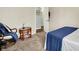 Inviting bedroom featuring a cozy chair, side table, and a bed with blue accents at 4824 Eagles Watch Ln, Indianapolis, IN 46254