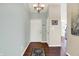 Inviting foyer with hardwood floors, white door, and neutral walls at 4824 Eagles Watch Ln, Indianapolis, IN 46254