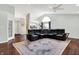 Open-concept living room with hardwood floors and comfortable seating arrangement at 4824 Eagles Watch Ln, Indianapolis, IN 46254