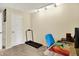 Cozy office space featuring a treadmill, desk with colorful accents, and neutral walls at 4824 Eagles Watch Ln, Indianapolis, IN 46254