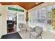 Bright sunroom featuring natural light, neutral furniture, wood ceiling, and access to the living room at 4824 Eagles Watch Ln, Indianapolis, IN 46254