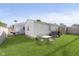 View of a large backyard including a table with four chairs, separated by a wood fence at 4967 Diana Dr, Indianapolis, IN 46203