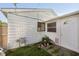 Back exterior featuring a white siding, a backdoor and a window with pretty pink flowers beneath at 4967 Diana Dr, Indianapolis, IN 46203