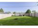 Large, green backyard with a wooden fence, mature trees, and plenty of room for recreation at 4967 Diana Dr, Indianapolis, IN 46203