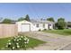 This house features a well-kept lawn, a detached garage, and is surrounded by lush greenery at 4967 Diana Dr, Indianapolis, IN 46203